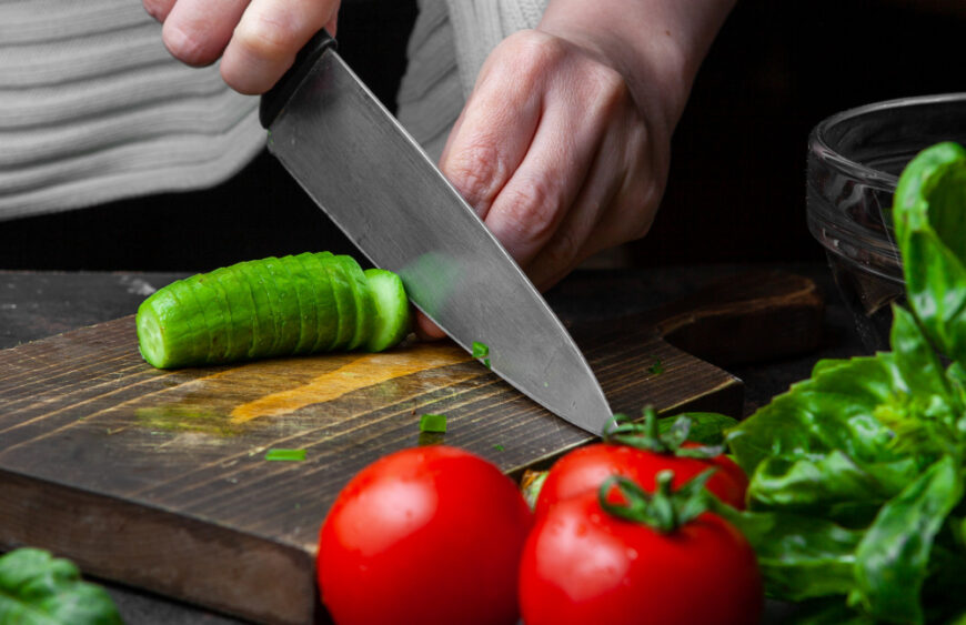 woman-cutting-cucumber-table