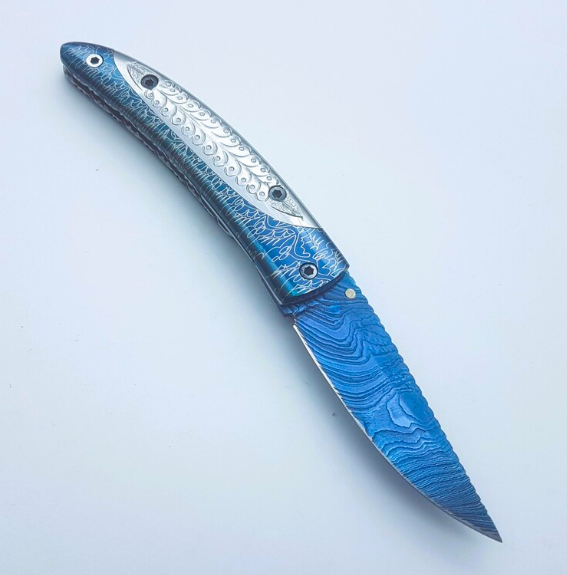 Handmade Folding Knife | Blue Titanium Damascus Blade | Hand-Carved Silver Handle |Box & Leather Sheath - Image 4
